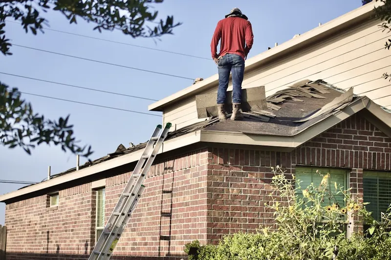 Professional roofer working on a residential roof in Morehousetown